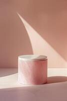 pink cylinder podium with marble lid on pink background photo