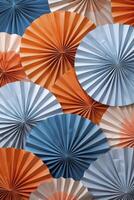 paper fan shape and pattern in shades of orange, blue and grey photo