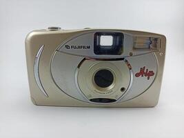 wonosobo central java indonesia august 7 2024 front view of fujifilm analog camera isolated on white background, antique camera photographic equipment photo