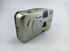 wonosobo central java indonesia august 7 2024 front view of fujifilm analog camera isolated on white background, antique camera photographic equipment photo
