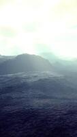 black volcanic dust and mountains with fog in background video