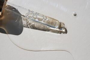 Pipette with serum on a beige background. photo