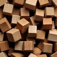 An arrangement of blank wooden cubes in a symmetrical grid, emphasizing the uniformity and repetition of shapes. The warm, natural tones of the wood add a touch of warmth to the structured design. photo