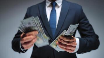 Formally dressed man is counting US Dollar bills quickly, close-up. video