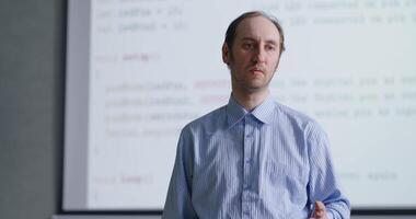 Portrait Of Middle-Aged School Teacher In Classroom Of Programming And Computer Science video