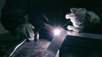 Welding in progress with intense light and sparks. A close-up of a worker performing a welding task video