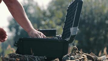 Male hands fold the drone and put it in a special protective case-bag. Close-up of hands folding a compact drone into a suitcase for storage. video