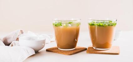 Spring iced scallion latte in glasses on the table web banner photo