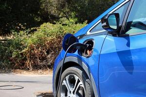 Electric car charging close-up. Light photo on a sunny day