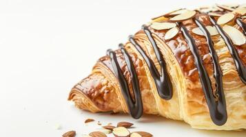Chocolate-drizzled croissant with almonds on white background photo