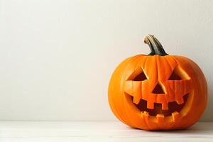 Carved Halloween pumpkin on rustic white background photo