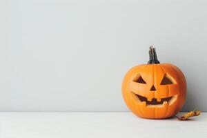 Carved Halloween pumpkin on rustic white background photo