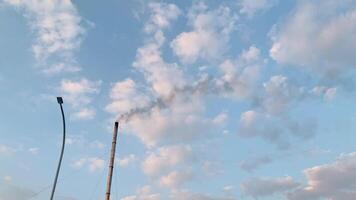 Smog and Sky. A photograph depicting smoke from a factory chimney against a blue sky with white clouds. It symbolizes industrial pollution and its impact on the environment. video
