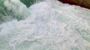 Ocean Waves Crashing on the Shore. Close up image of ocean waves crashing on the shore, creating white foam and turquoise water. video
