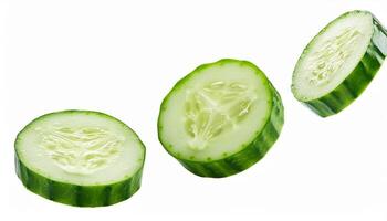 Falling green cucumber slice isolated on white background, full depth of field. photo