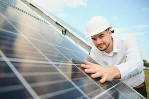 The solar farm, solar panel with engineer check the operation of the system, Alternative energy to conserve the worlds energy, Photovoltaic module idea for clean energy production. photo