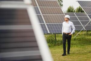 The solar farm, solar panel with engineer check the operation of the system, Alternative energy to conserve the worlds energy, Photovoltaic module idea for clean energy production. photo