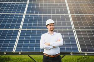 The solar farm, solar panel with engineer check the operation of the system, Alternative energy to conserve the worlds energy, Photovoltaic module idea for clean energy production. photo