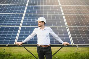 The solar farm, solar panel with engineer check the operation of the system, Alternative energy to conserve the worlds energy, Photovoltaic module idea for clean energy production. photo