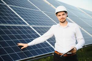 The solar farm, solar panel with engineer check the operation of the system, Alternative energy to conserve the worlds energy, Photovoltaic module idea for clean energy production. photo