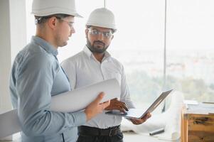 two architect engineers are walking in a constructed office building. implementation of the project photo