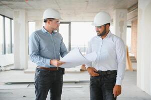 two architect engineers talking in a constructed office building photo