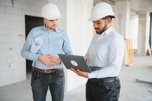 two architect engineers are walking in a constructed office building. implementation of the project photo