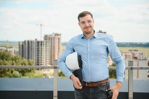 Man builder. Architect at construction site photo