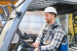 Man worker at forklift driver happy working in industry factory logistic ship photo
