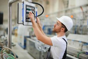 Factory worker. Man working on the production line photo