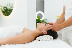 Theres no better way to relax. Shot of an attractive woman enjoying a face massage photo