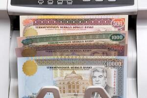 Turkmenistani manat in the counting machine photo