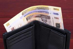 Congolese money in the black wallet photo