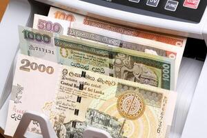 Old Sri Lankan rupee in the counting machine photo