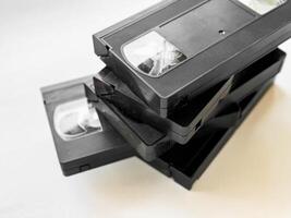 Stack of vintage vhs cassettes on light background photo