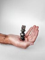 Balancing polyhedral dice in hand. precision and gaming aesthetics photo