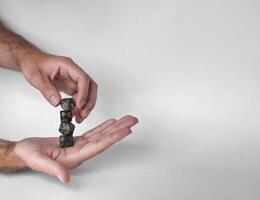 Hands rolling unique polyhedral dice in mid-air against a minimalistic background photo