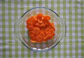 sliced carrots in microwave dish top view photo