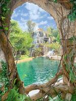 Closeup view of a beautiful waterfall and bright blue sky with clouds through holes in trees and then vines. photo