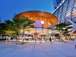 Bangkok city, TH 2022 - Front of the Apple store at the Central world shopping mall on office building and cityscape background., This store is the 2nd branch in Thailand. photo