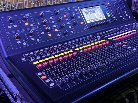 Closeup and crop of knobs with button of sound music mixer control panel in party purple lights. photo