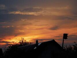 house silhouette against the background of a bright sunrise photo