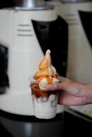 Ice latte coffee with scoop of vanilla ice cream and on black table at coffee shop. photo