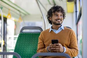 Smiling man sitting on bus seat using smartphone during commute. Relaxed expression capturing moment of joy and connectivity. Concept of travel, technology, public transportation. photo