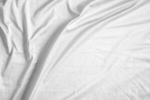 Abstract white wrinkled bedding sheet fabric texture background photo