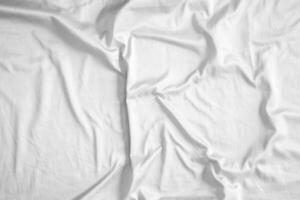 Abstract white wrinkled bedding sheet fabric texture background photo