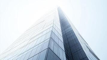 A modern skyscraper viewed from below, showcasing sleek glass and steel architecture. photo