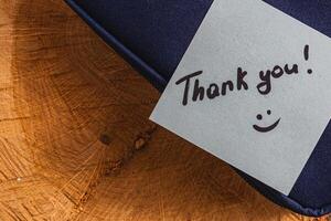 The word thank you on a note on a soft box photo