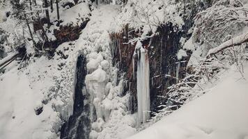 Huk waterfall, frozen waterfall at winter, Carpathian National Park. Ukraine. photo