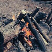 Brew coffee in a Turk on an open fire. photo